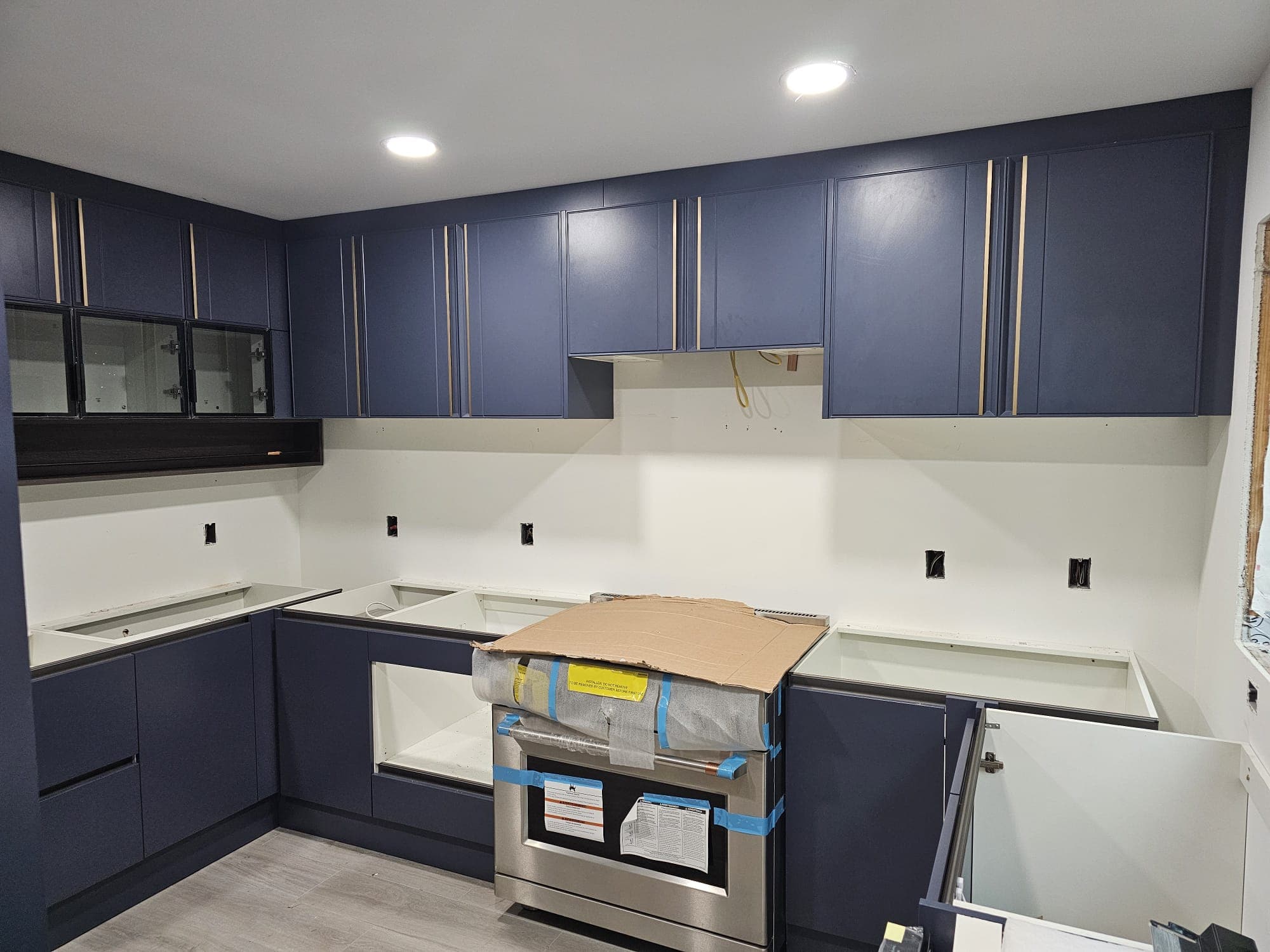 Navy blue kitchen cabinets during installation